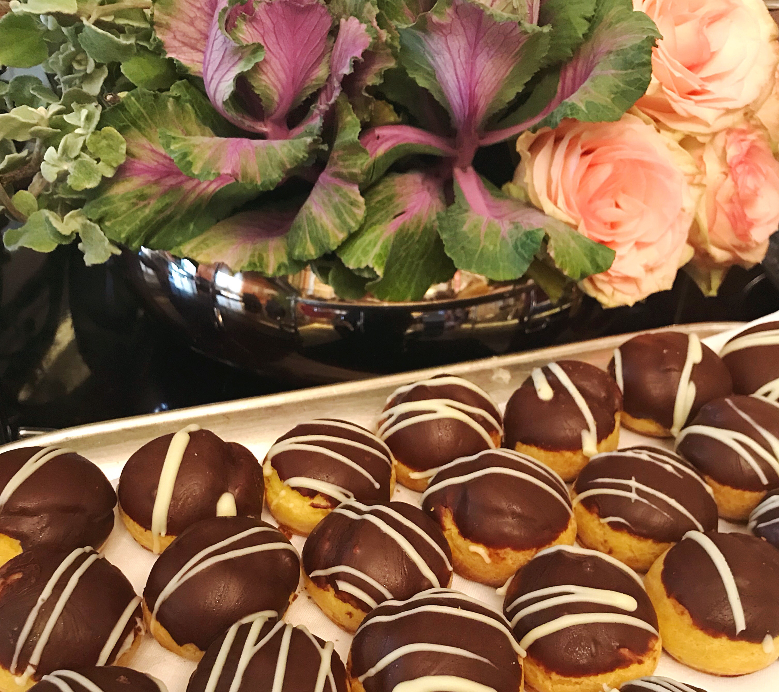 Sweet treats for high tea at the Belmond Mount Nelson, with flowers in the background