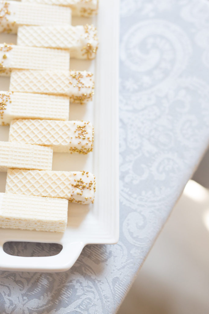 Chocolate dipped wafer biscuits with gold sprinkles on the edges for a welcome baby celebration