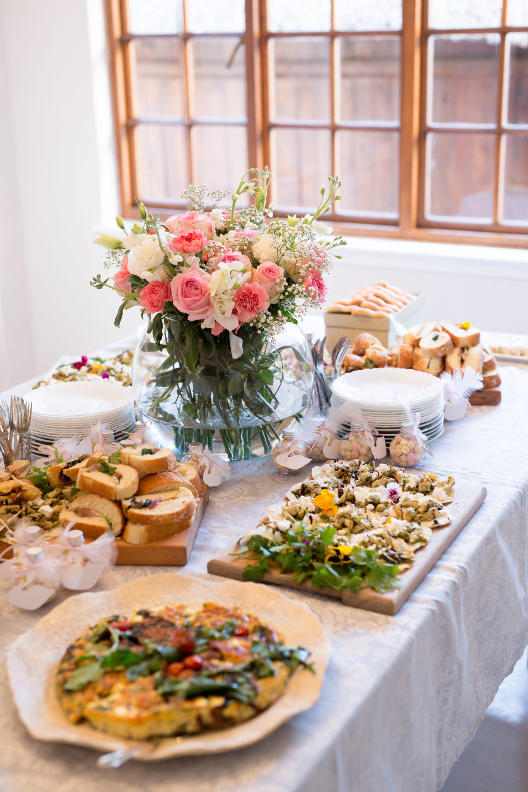 Welcome to the world baby celebration with a swan theme and lots of savoury snacks on wooden servers