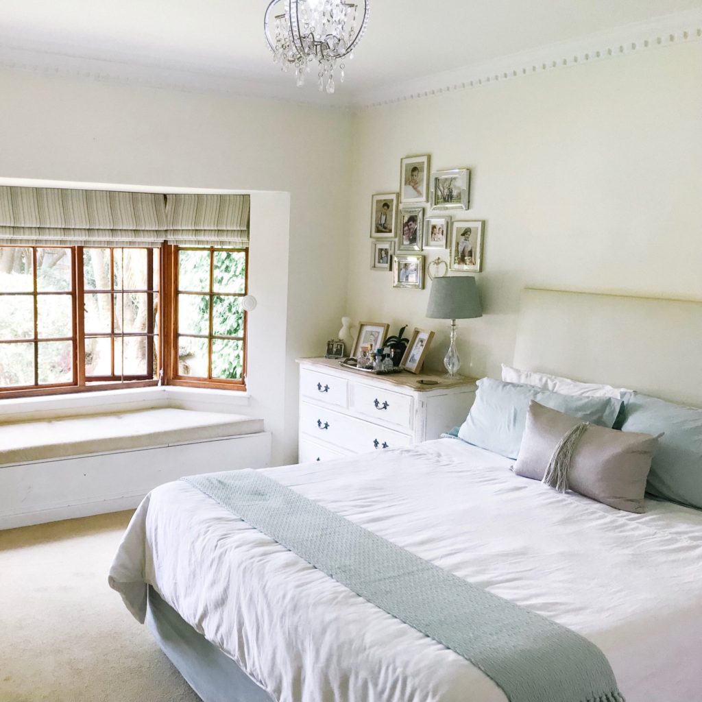 Master bedroom with carpet and built-in wall bench