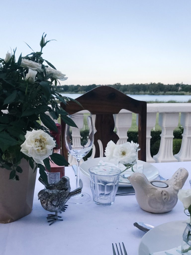 simple table setup, potted rose, bird decor, neutral tablescape