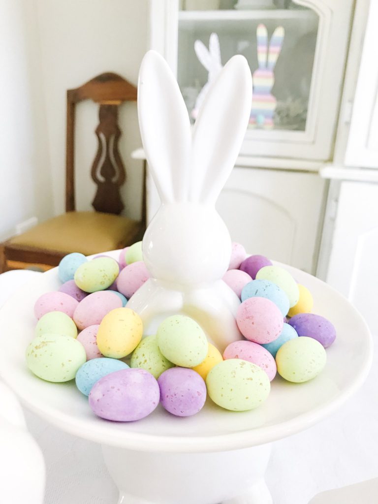 White ceramic bunny cake stand with speckled eggs
