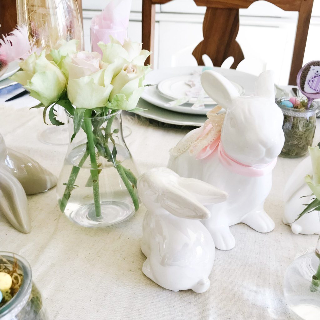 White ceramic bunnies, pastel Easter table