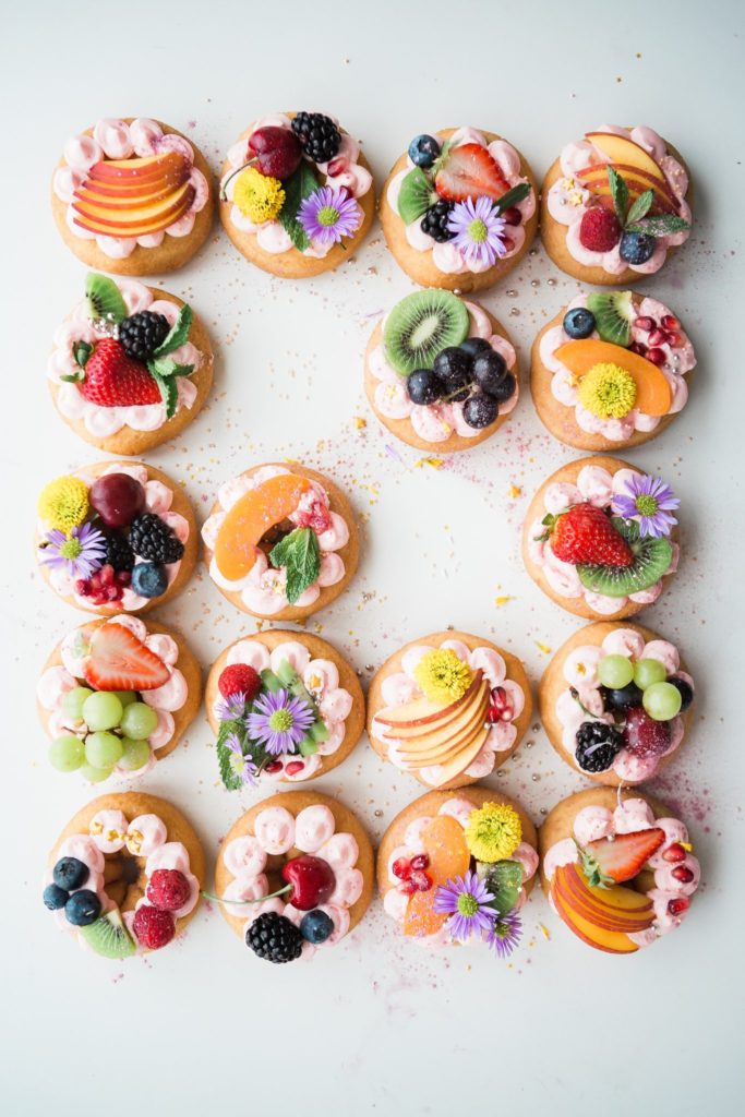 Delectable donuts topped with a variety of fruits and flowers