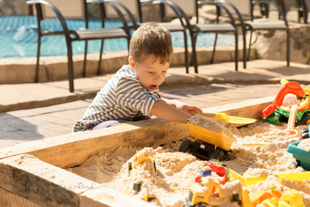 Playing with dump trucks and diggers in the sand at a construction birthday party!