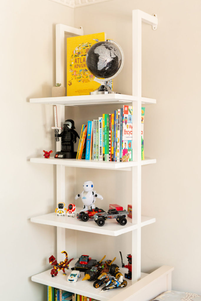 White bookcase in shared boys bedroom
