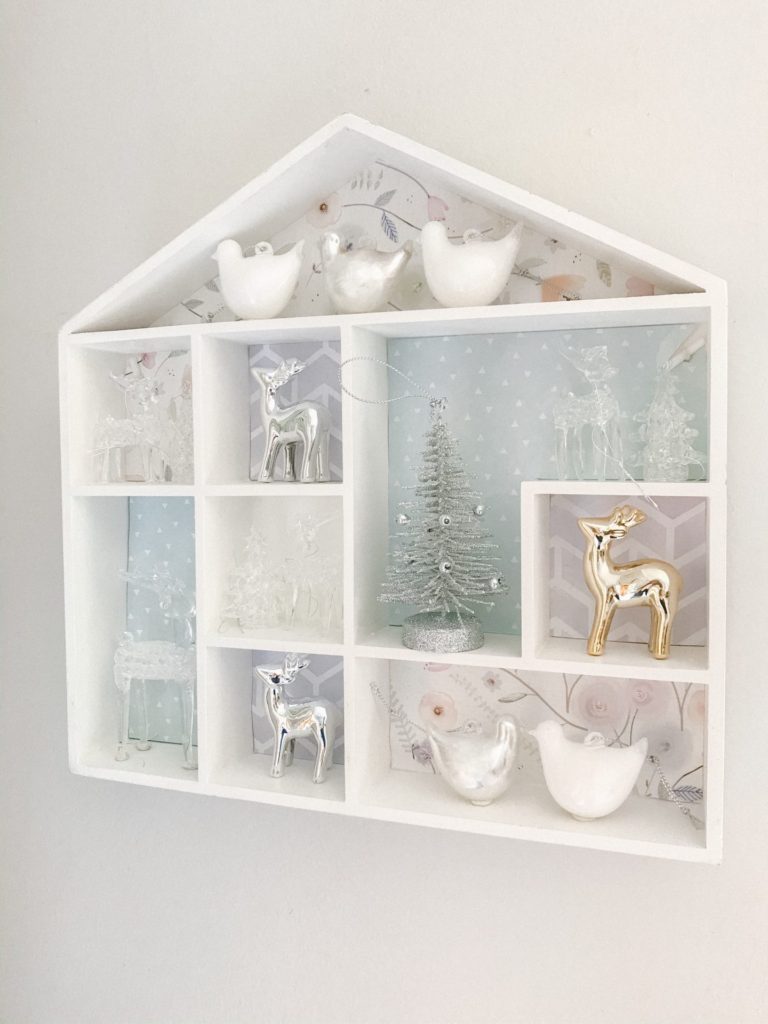 House wall shelf on the wall with paper and Christmas ornaments