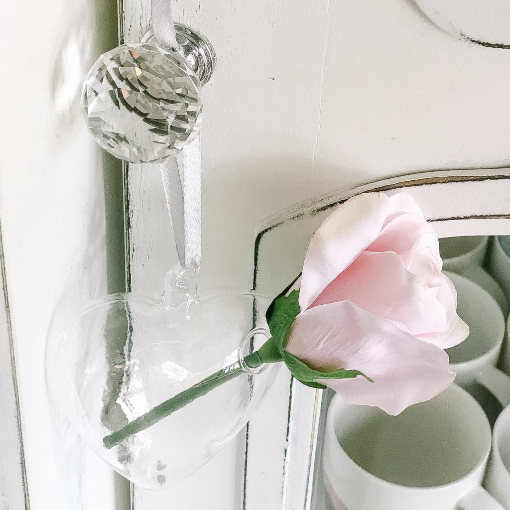 Top Post 2: Crystal cabinet knob with glass vase and single pink rose
