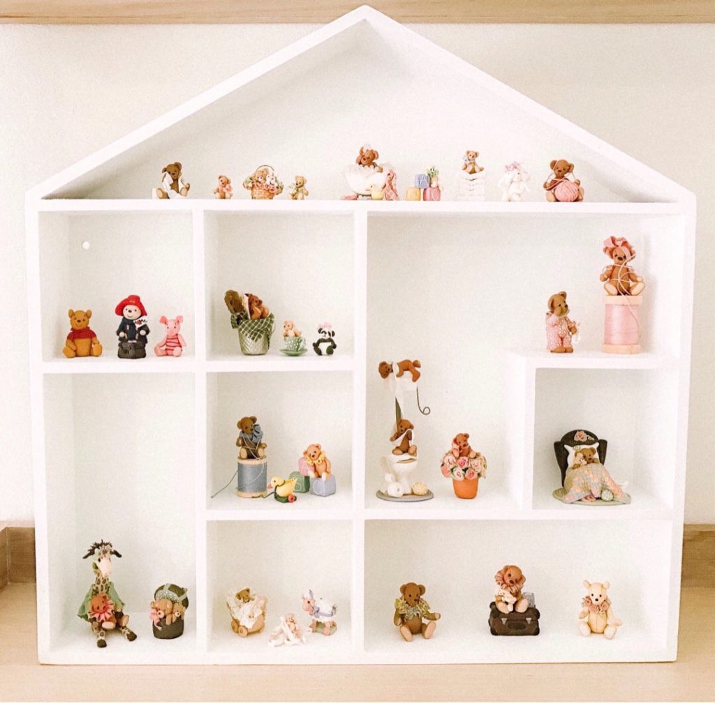 Top Post 8: Miniature collection of polymer clay ornaments in a house wall shelf